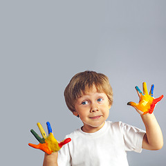 Image showing boy with hands painted in colorful paints