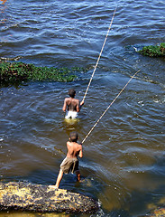 Image showing Children fishing in the sea