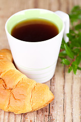 Image showing cup of tea and fresh croissant