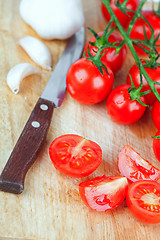 Image showing fresh tomatoes, garlic and old knife 