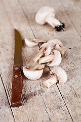 Image showing sliced champignons and old knife