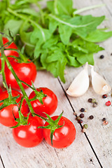 Image showing fresh tomatoes, rucola, garlic and peppercorns