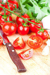 Image showing fresh tomatoes, rucola, garlic and old knife 