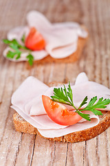 Image showing bread with sliced ham, fresh tomatoes and parsley