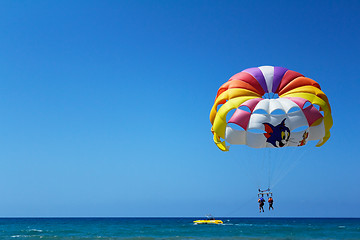 Image showing Big beautiful parachute in the air over the sea.