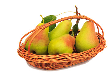 Image showing Large ripe pears in a wicker basket on a white background.