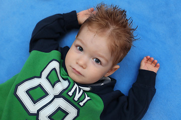 Image showing Portrait of little boy lying on floor 