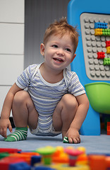 Image showing A happy baby boy on a floor
