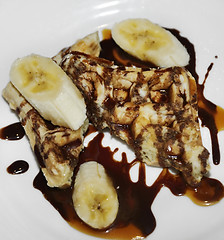 Image showing Waffles With Bananas And Chocolate Syrup