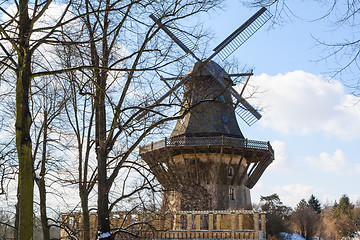 Image showing Old wind mill at the winter forest landscape