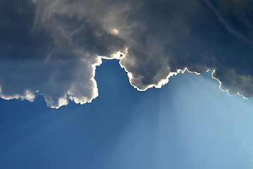 Image showing The sunshine which are looking out because of clouds