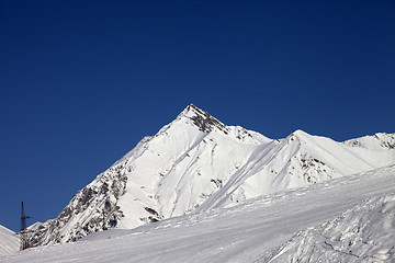 Image showing Ski slope and blue clear sky at sunny day