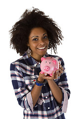 Image showing Young african american woman with piggy bank