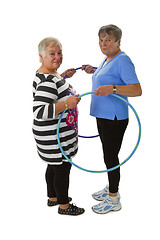 Image showing Senior lady doing gymnastic with hula hoop