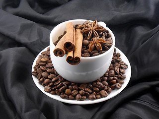 Image showing cup of cofee with cinnamon in black background