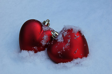 Image showing Two red hearts in the snow