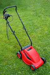 Image showing new lawnmower on green grass