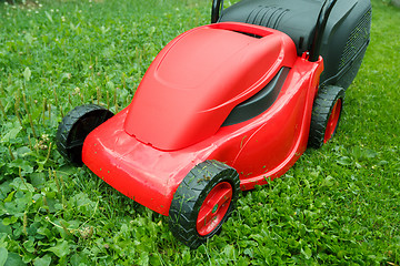 Image showing new lawnmower on green grass