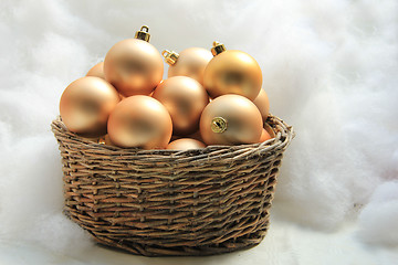 Image showing Golden Christmas ornaments in a wicker basket