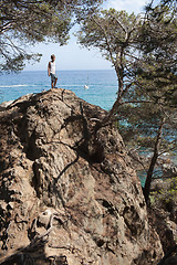 Image showing Young  boy on rocky coastline