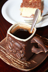 Image showing cup of coffee and portion cake