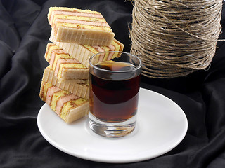 Image showing Champagne, glasses and cake on black material