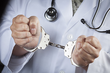 Image showing Doctor or Nurse In Handcuffs Wearing Lab Coat and Stethoscope