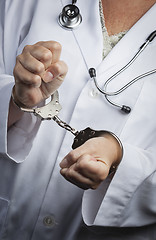 Image showing Doctor or Nurse In Handcuffs Wearing Lab Coat and Stethoscope