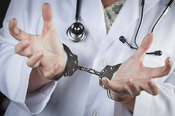 Image showing Doctor or Nurse In Handcuffs Wearing Lab Coat and Stethoscope
