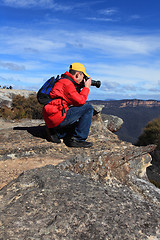 Image showing Photographer taking photos of mountain landscape