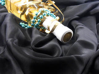 Image showing bottle of champagne wine with blue diamonds on black material background