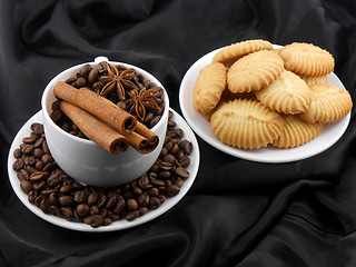 Image showing Cup of coffee with cinnamon, cake and coffee beans