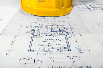 Image showing Yellow helmet of an engineer with plans