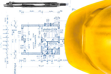 Image showing Yellow helmet of an engineer with plans