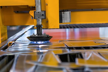 Image showing Machine cutting steel in a factory