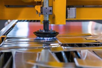 Image showing Machine cutting steel in a factory