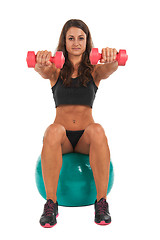 Image showing Young woman in the studio with weights