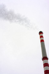 Image showing Industrial chimney against cloudy sky