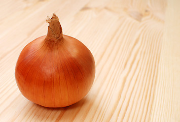 Image showing Whole white onion on a wooden table