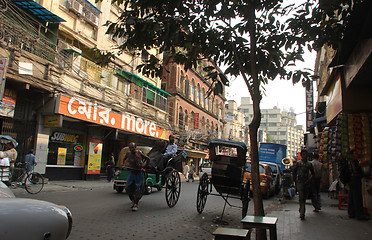 Image showing Rickshaw man pulls the customer in the streets of Kolkata