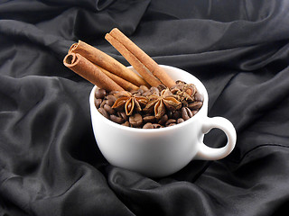 Image showing Composition with white cup of coffee, coffee beans and cinnamon