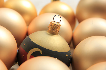 Image showing Red ornament on a pile of golden ornaments