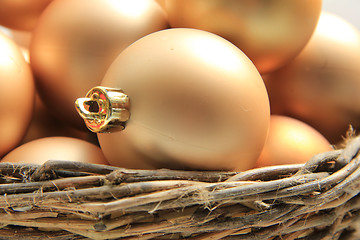 Image showing Golden Christmas ornaments in a wicker basket