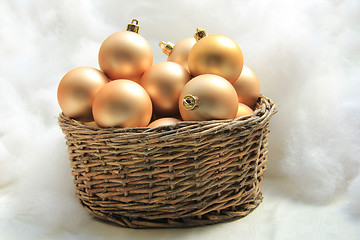 Image showing Golden Christmas ornaments in a wicker basket
