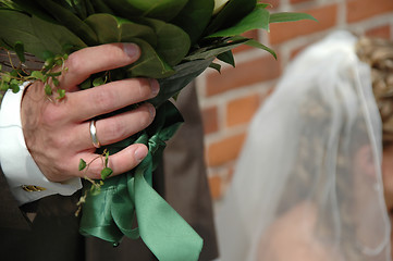 Image showing Groom holding flowers