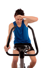 Image showing Exhausted after workout on exercise bike