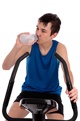 Image showing Teenager using exercise bike fitness gym