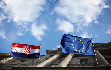 Image showing Flags with cloudy sky