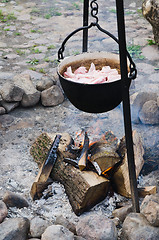 Image showing old pot for cooking over a campfire, close-up. 