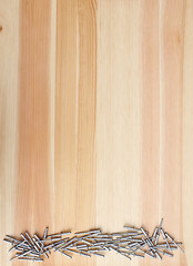 Image showing Metal pop rivets on wood